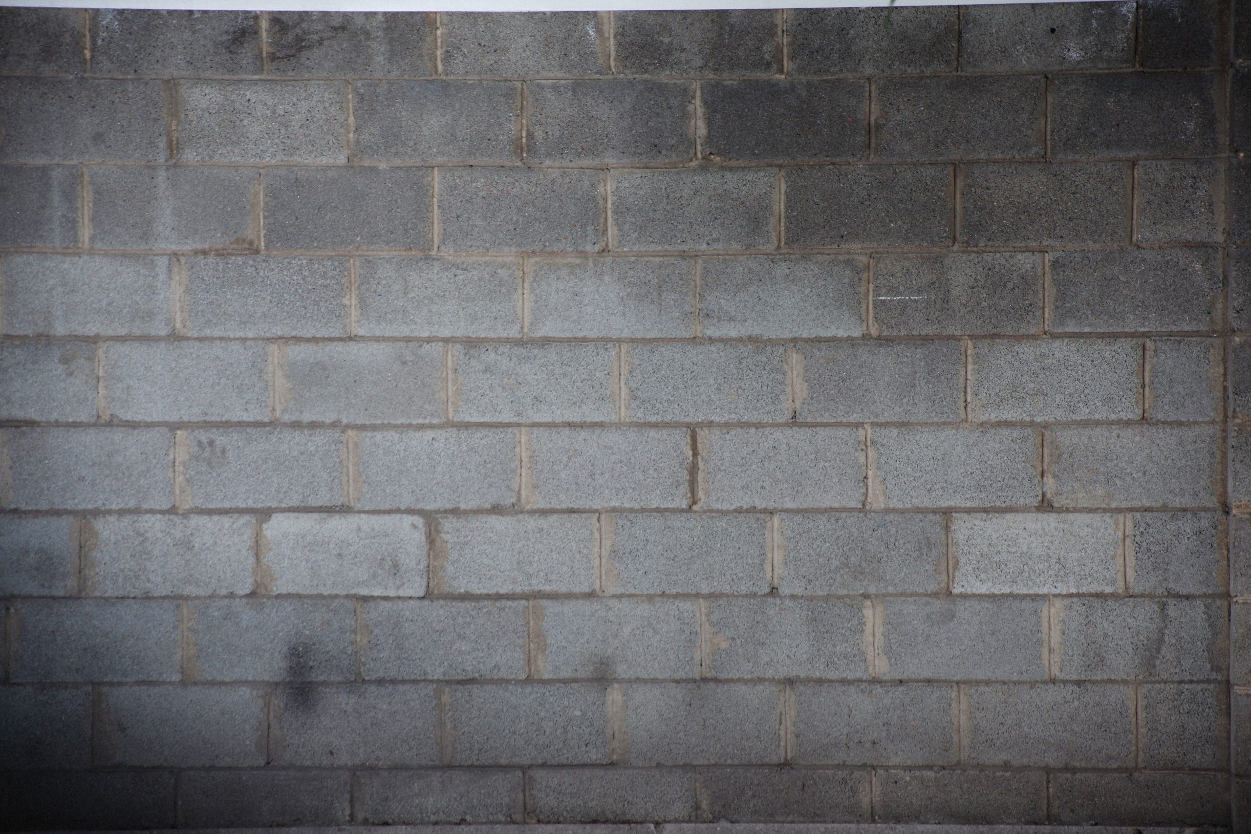 Texture rugueuse d'un mur en bloc de béton